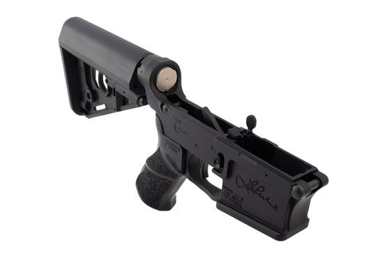 This AR-15 lower receiver features a pistol grip and collapsible stock.